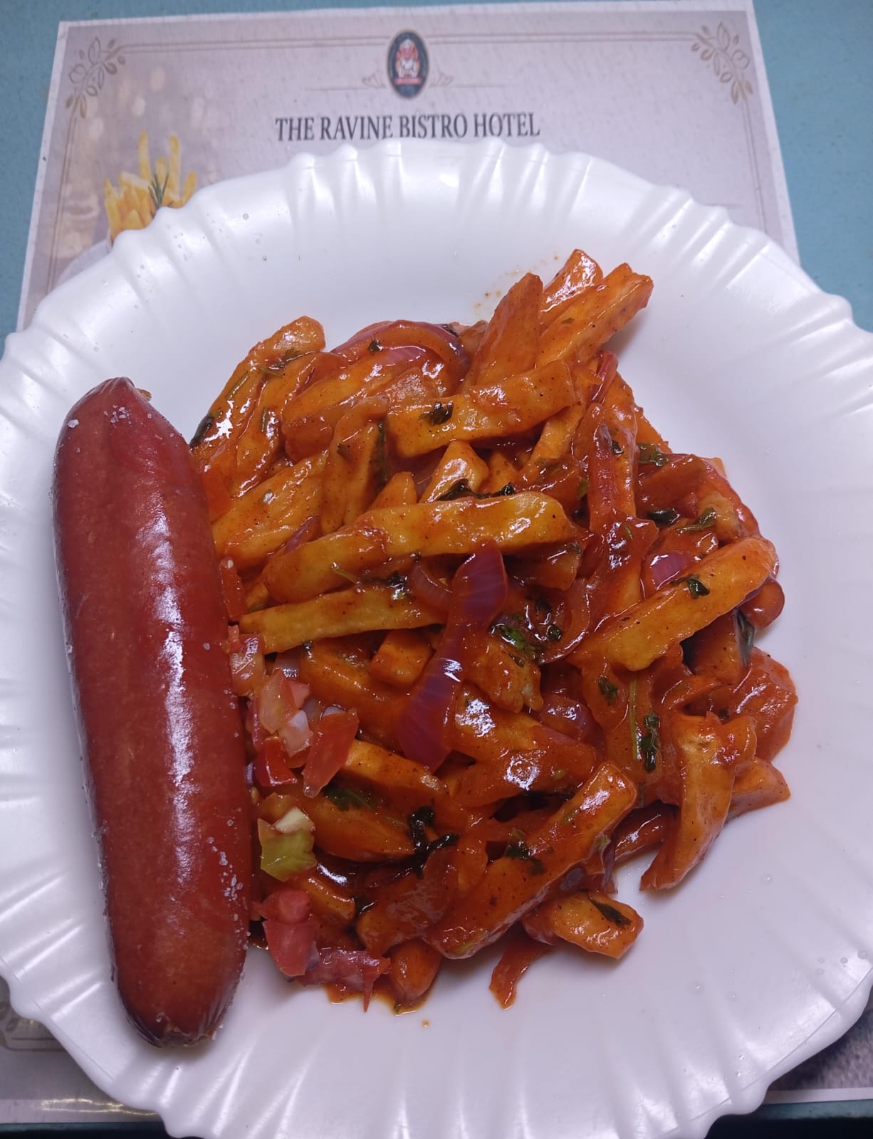 Chips masala with sausage served at Ravine Bistro Kitchen in Eldama Ravine